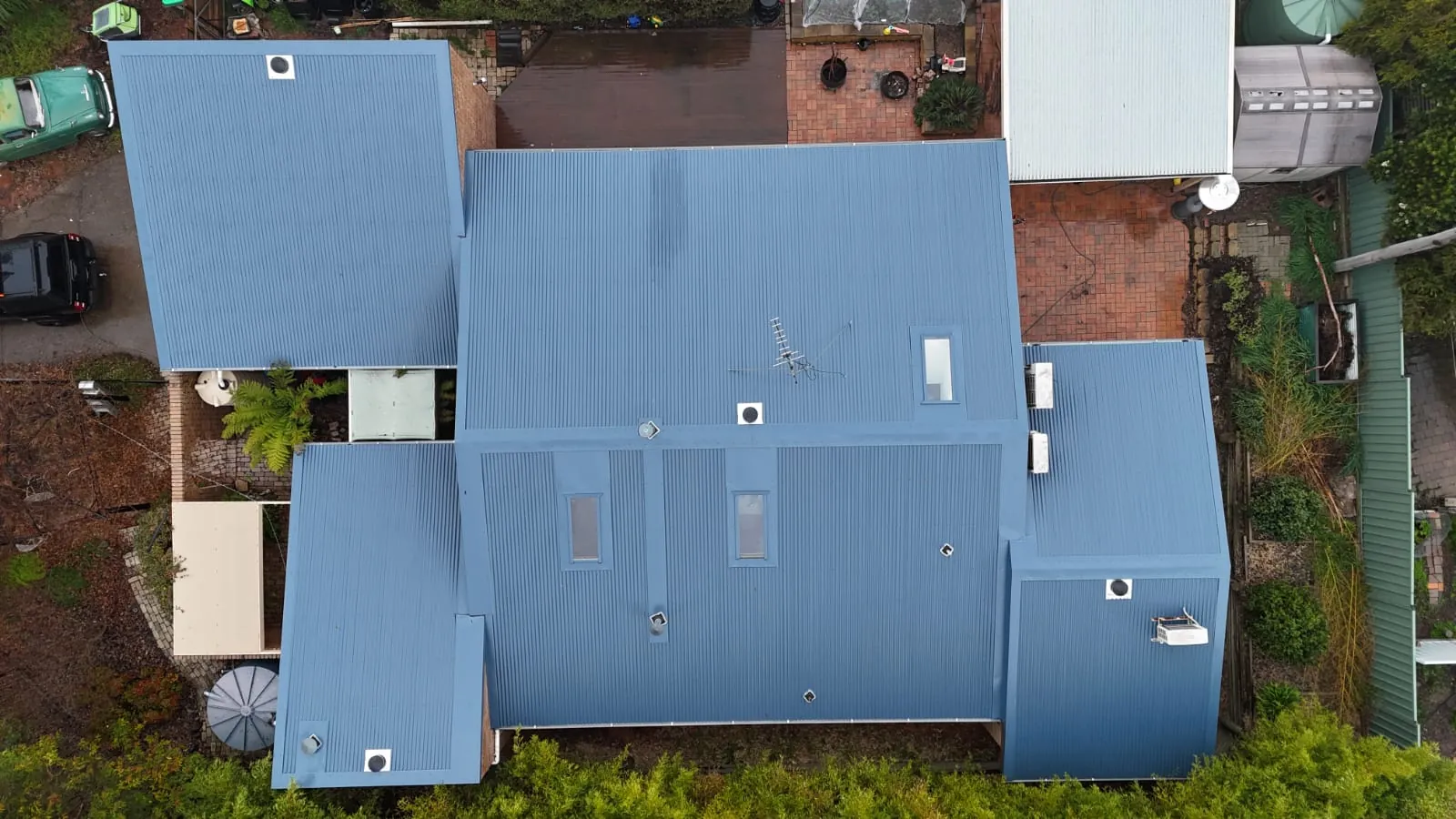 Drone shot looking straight down on a new blue-grey metal roof