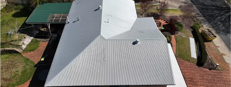 After: the same home re-roofed in pale grey Colorbond