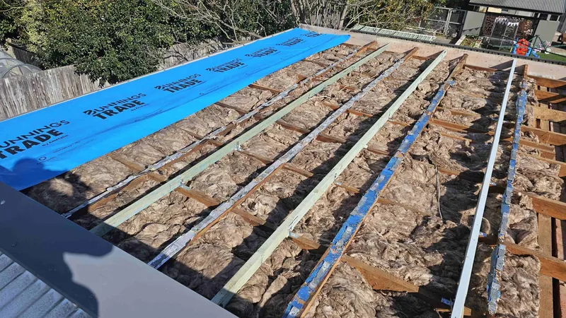 New metal battens and blue sarking laid over insulation