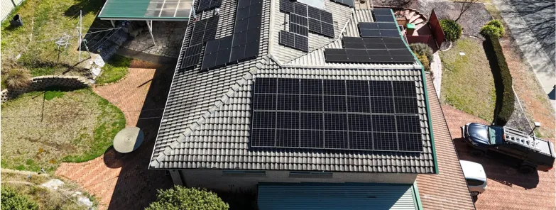 Before: drone view of a concrete tile roof covered in solar panels